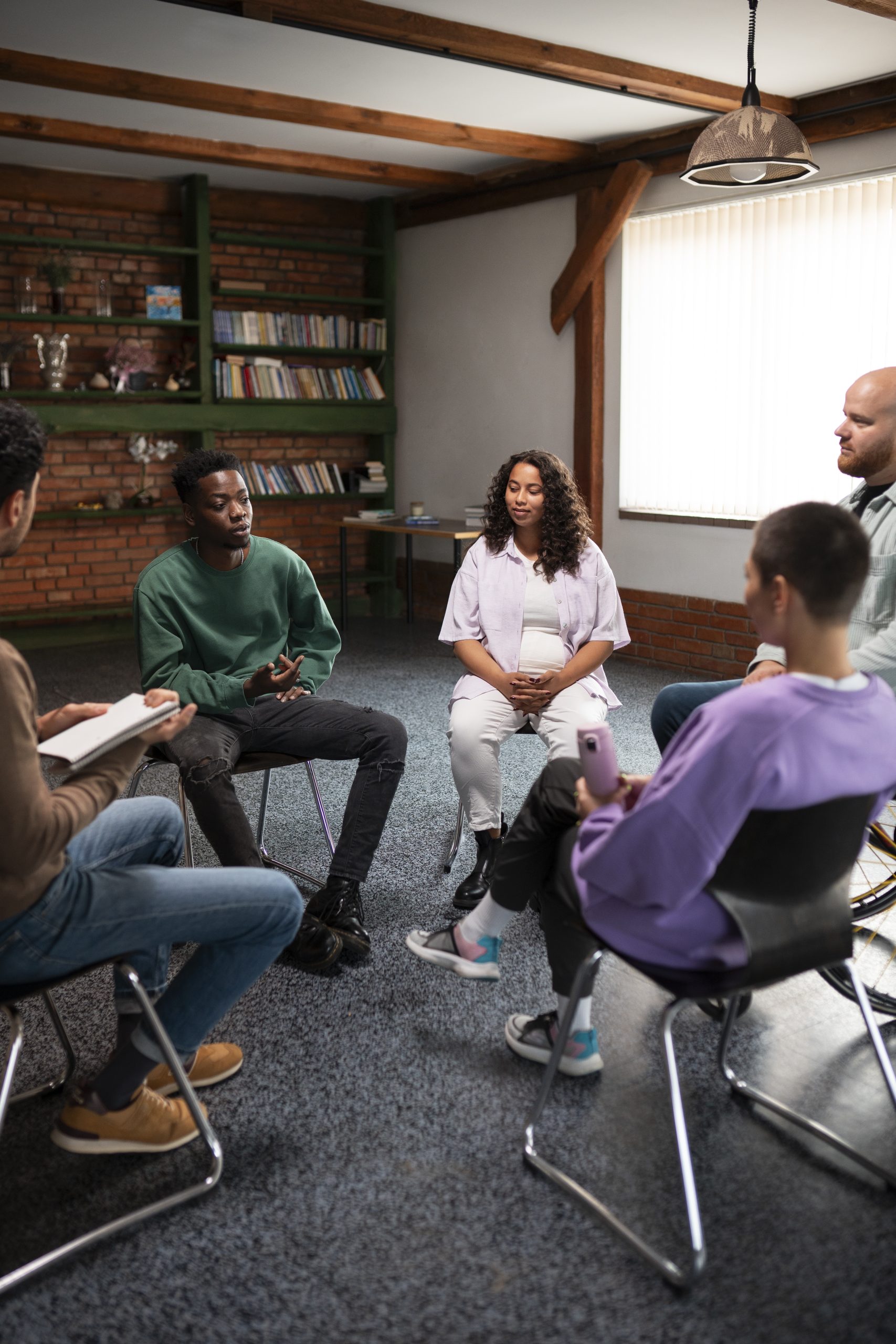 Members sitting in a circle during a support group meeting